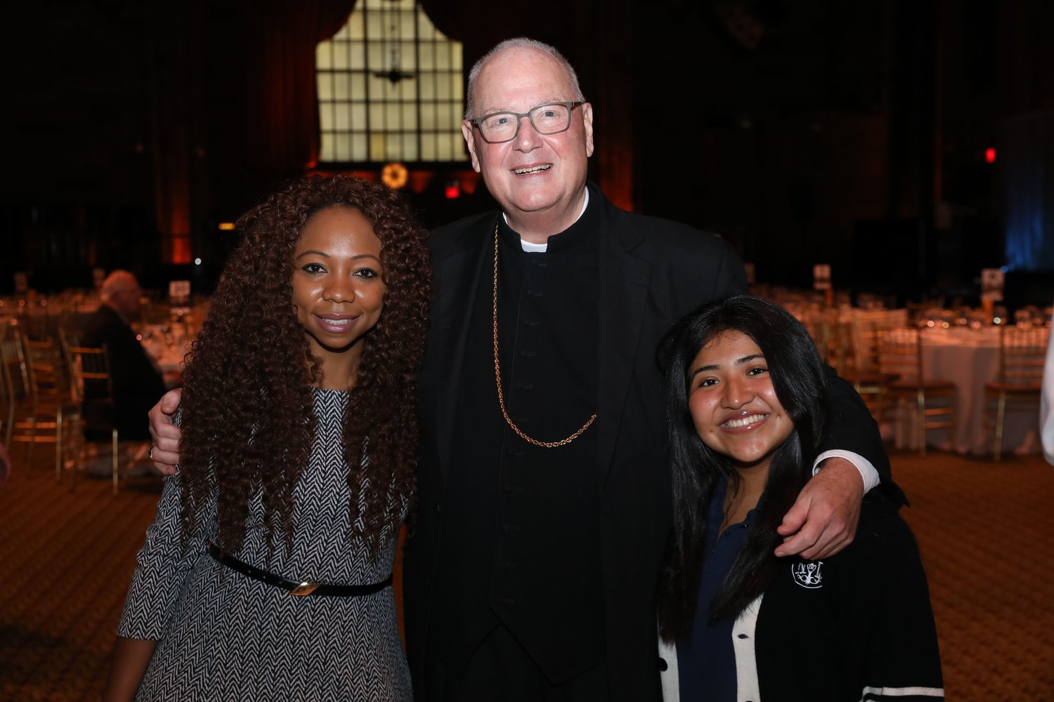 Cardinal Dolan greets attorney Latrisha Desrosiers and Susan Saldago, a student at Notre Dame School in Manhattan.